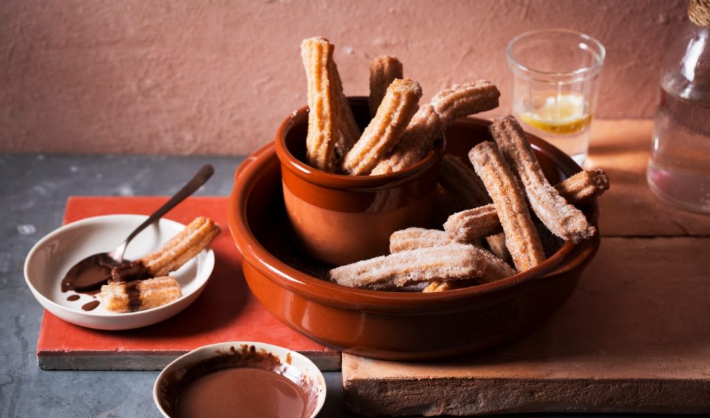 Crispy golden churros served with rich salted chocolate sauce, fried using Moro Light Taste Olive Oil — a sweet twist on cooking with Olive Oil