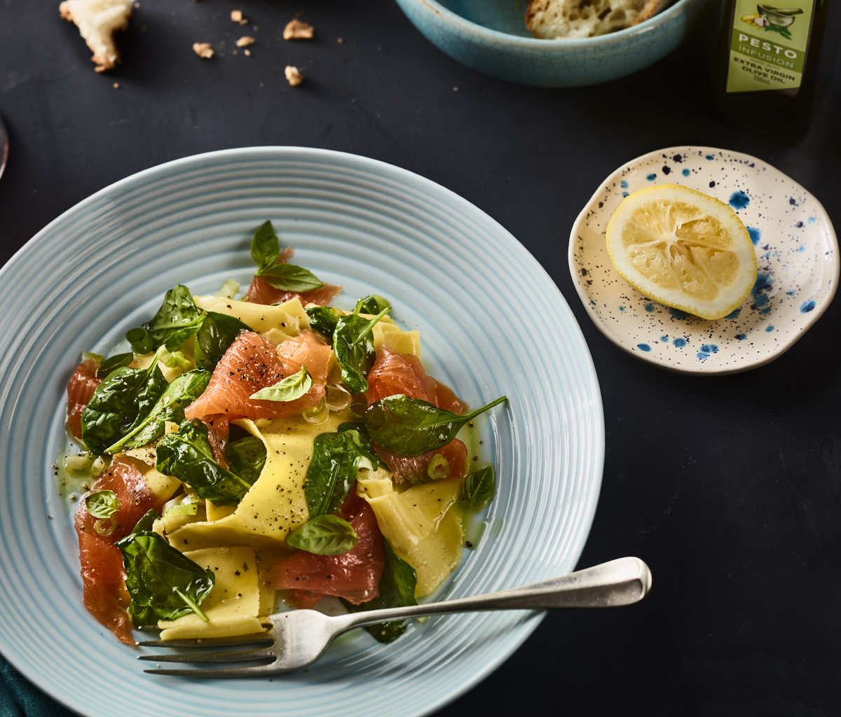 Torn pasta with smoked salmon and spinach, dressed with a drizzle for precision of refillable bottle Extra Virgin Olive Oil for healthy eating.